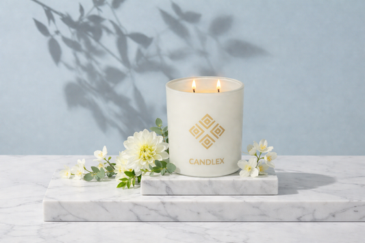 candlex white intense high quality candle in a white marble base surrounded by flowers